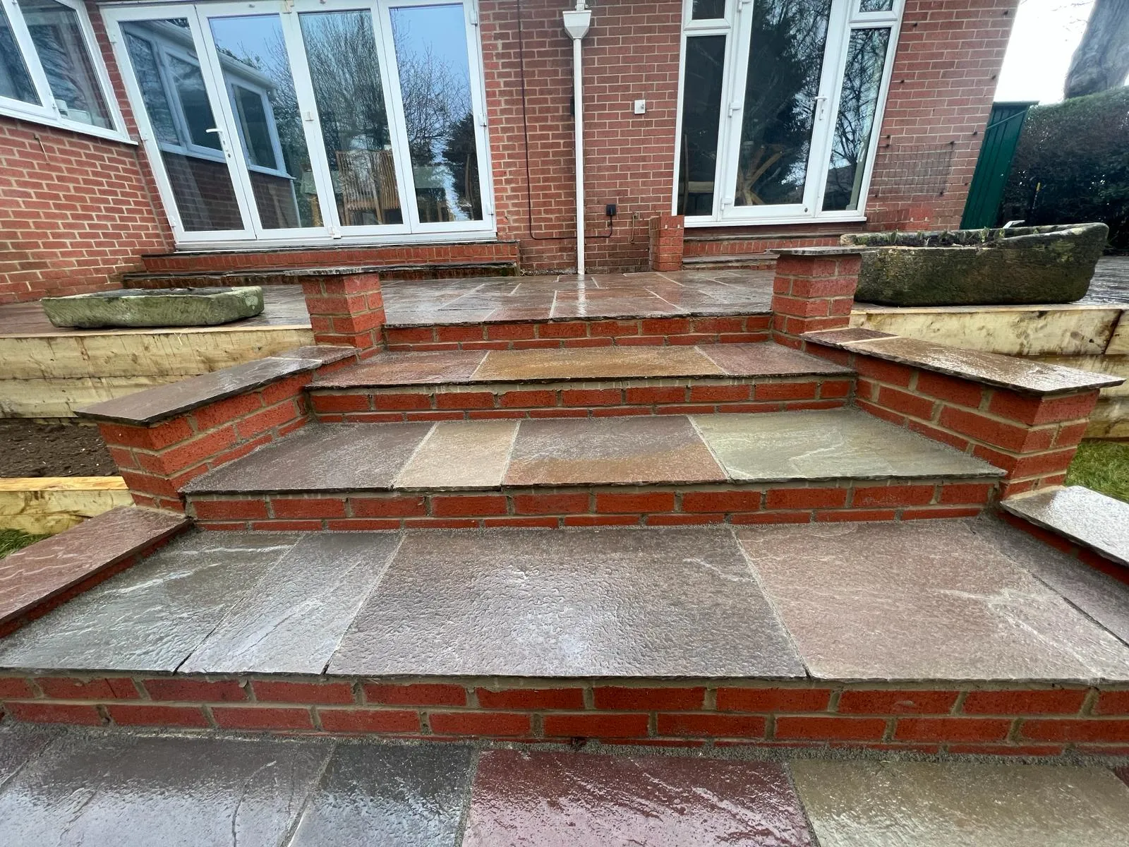 A set of stone steps leading to a brick building.